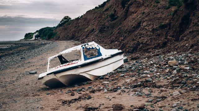 Boat washed up on rocks